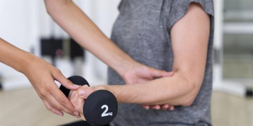 medical-assistant-helping-patient-with-physiotherapy-exercises